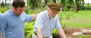 man assisting old man to walk